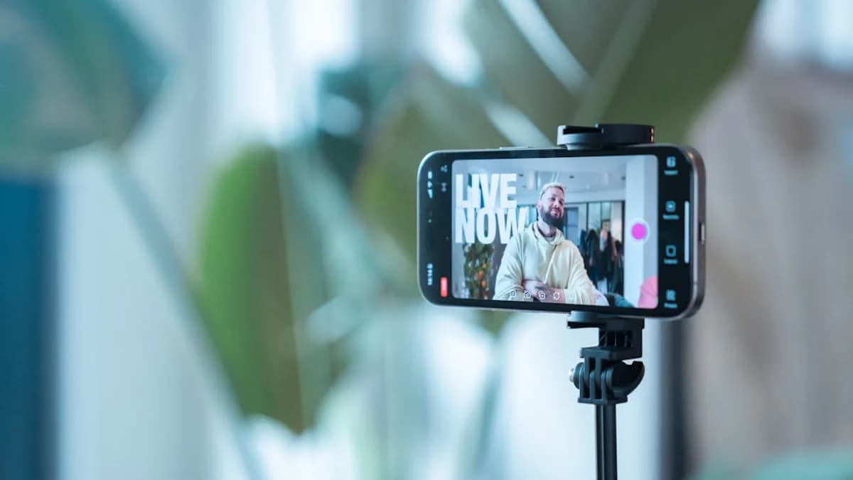 Smartphone recording a man speaking on live stream.