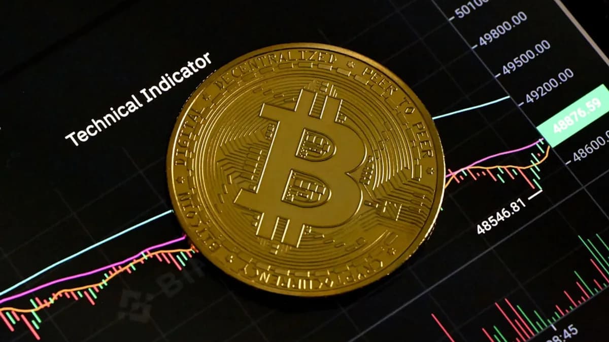 a bit coin sitting on top of a stock chart