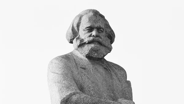 gray scale photo of man statue