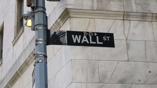 a street sign on the corner of wall street