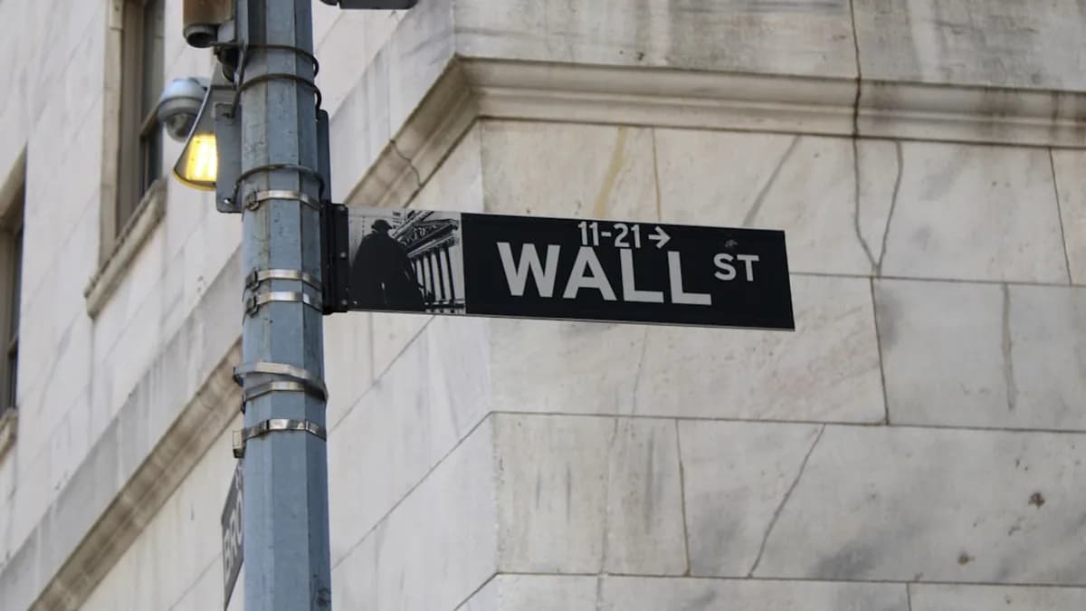 a street sign on the corner of wall street