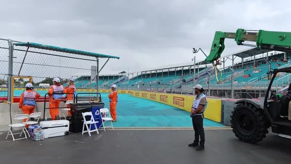 People prepare for a race at a formula 1 track.