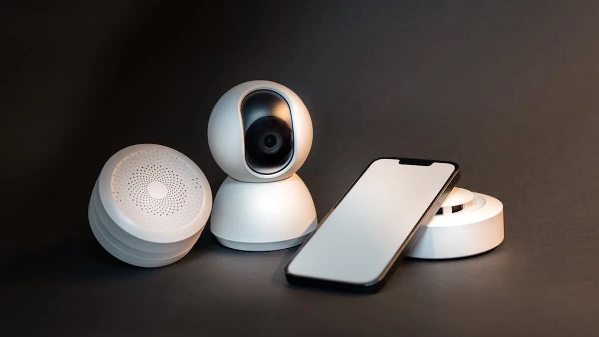 a smart phone sitting next to a wireless security camera