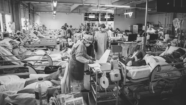 a black and white photo of people in a hospital