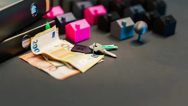 Real estate concept with money, keys, and tiny houses.