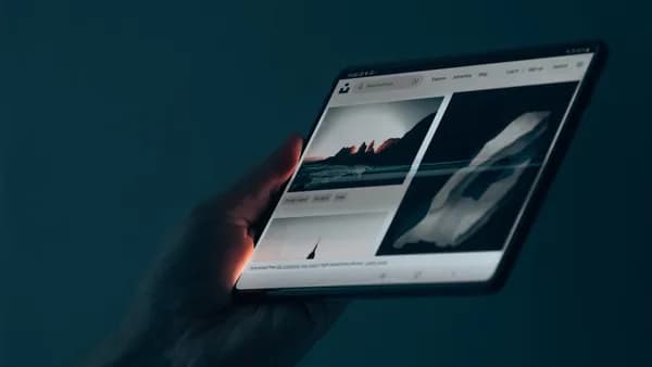 a hand holding a tablet