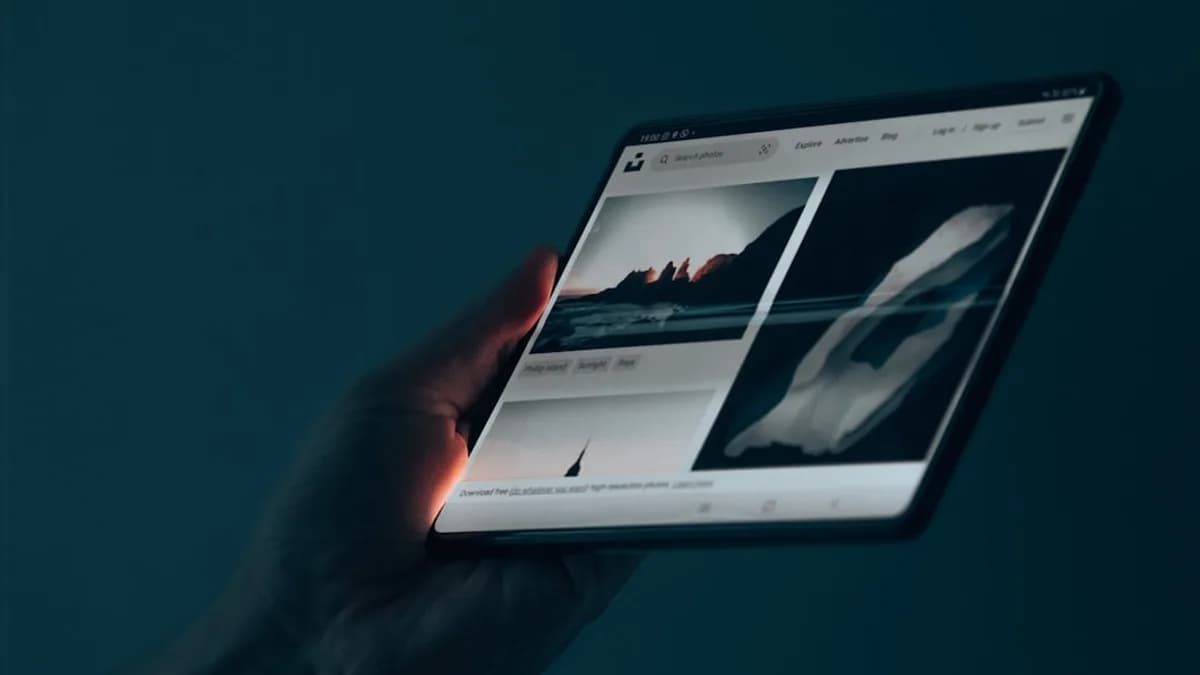 a hand holding a tablet