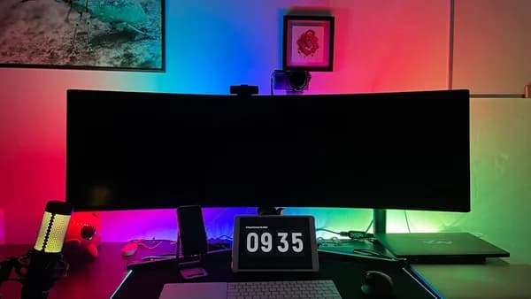 a desk with a laptop and a clock on it