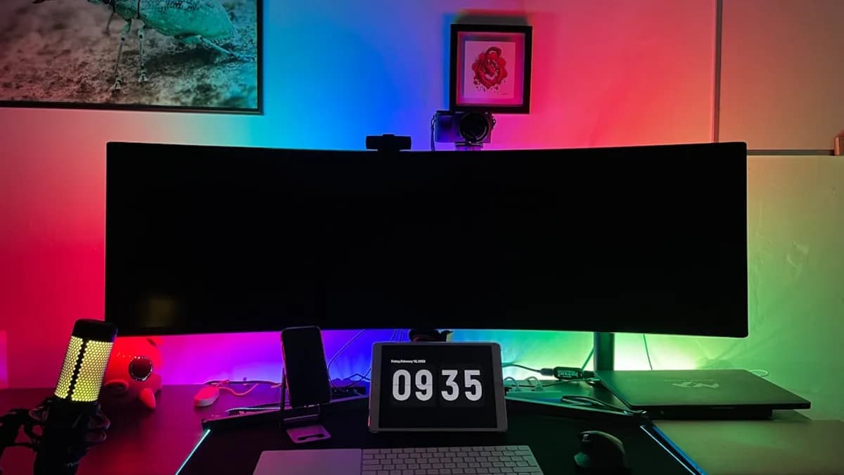 a desk with a laptop and a clock on it