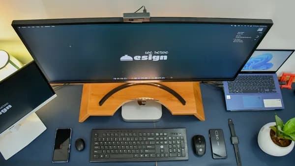 a desk with a computer and a phone