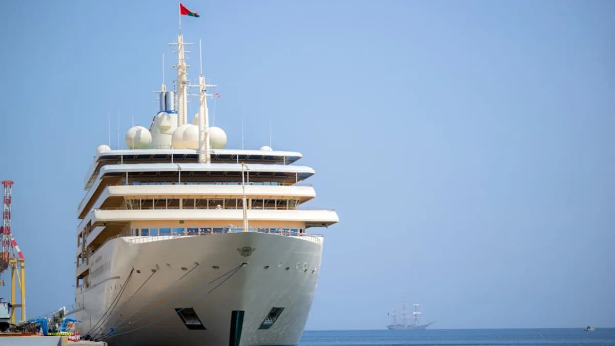 cruise ship parked beside tower