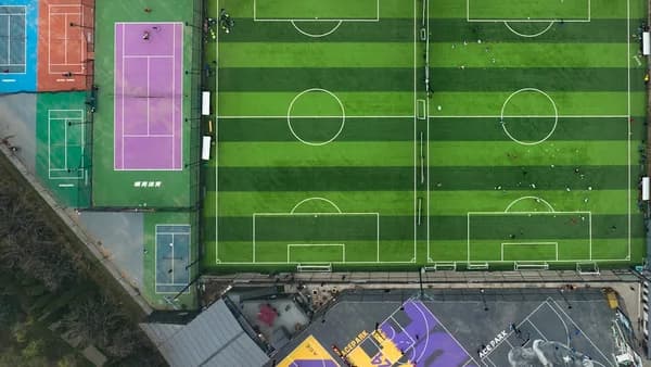 an aerial view of a soccer field in a city