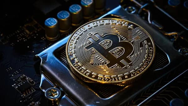 a bitcoin on top of a computer motherboard