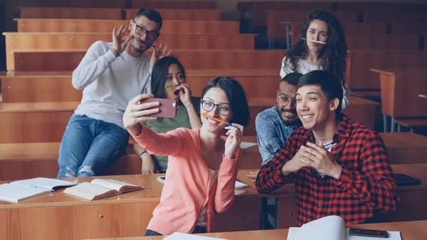 Students taking a selfie in a lecture hall
