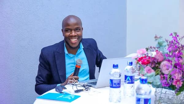 A man sitting at a table with a laptop