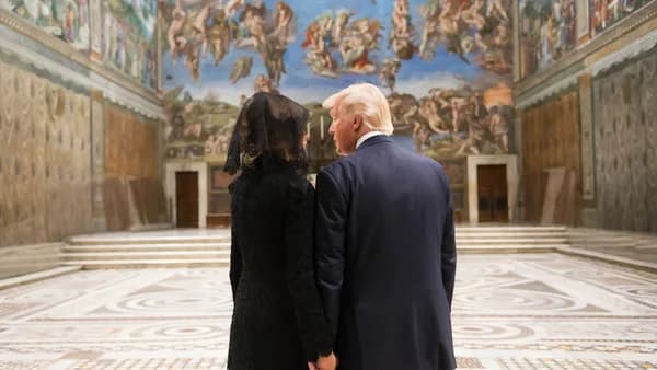 man in black suit standing beside woman in black dress