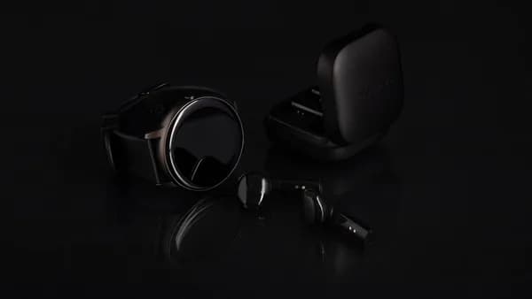 a pair of headphones and ear buds on a black surface