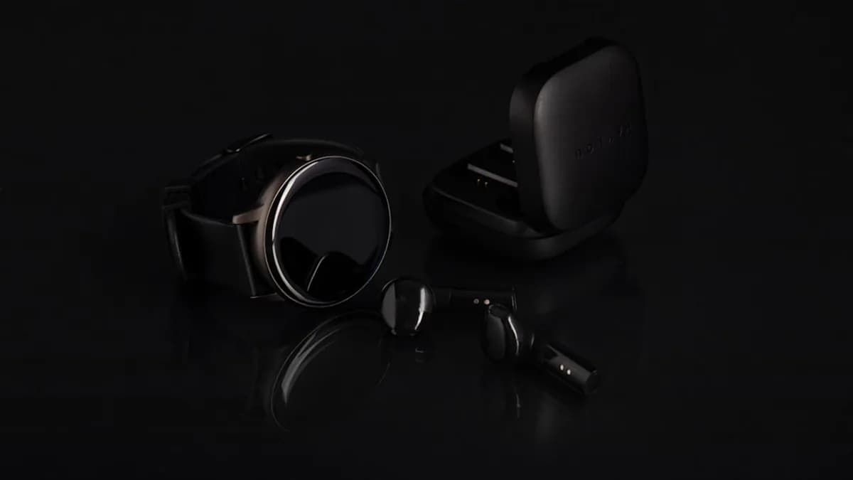 a pair of headphones and ear buds on a black surface