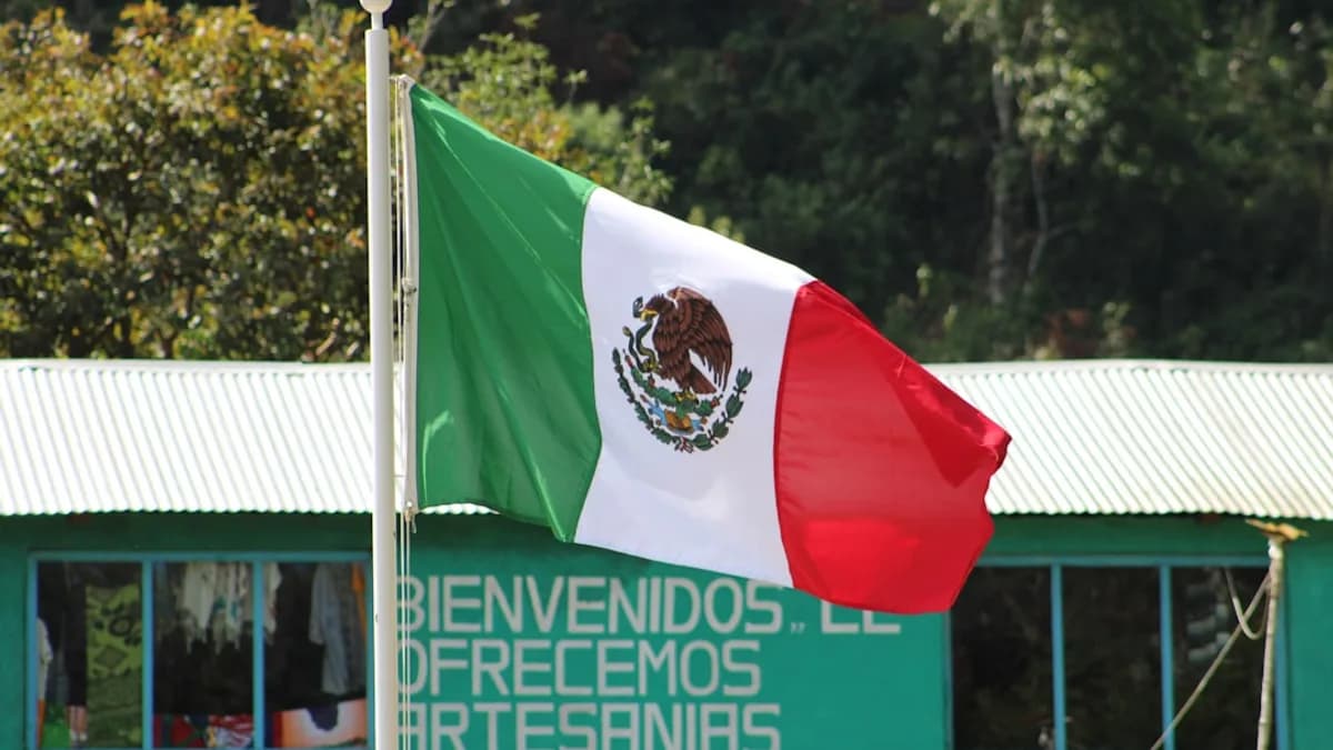 a mexican flag flying in front of a building