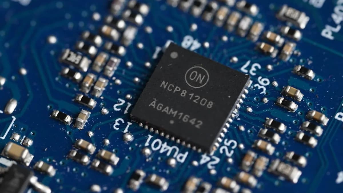 Close-up of a computer chip on a blue circuit board.