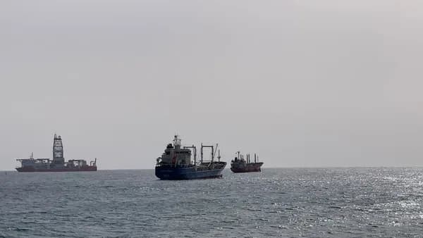 black ship on sea under white sky during daytime