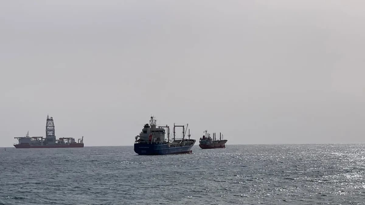 black ship on sea under white sky during daytime