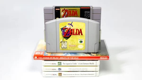 a nintendo game console sitting on top of a stack of books