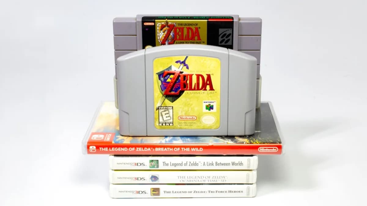 a nintendo game console sitting on top of a stack of books