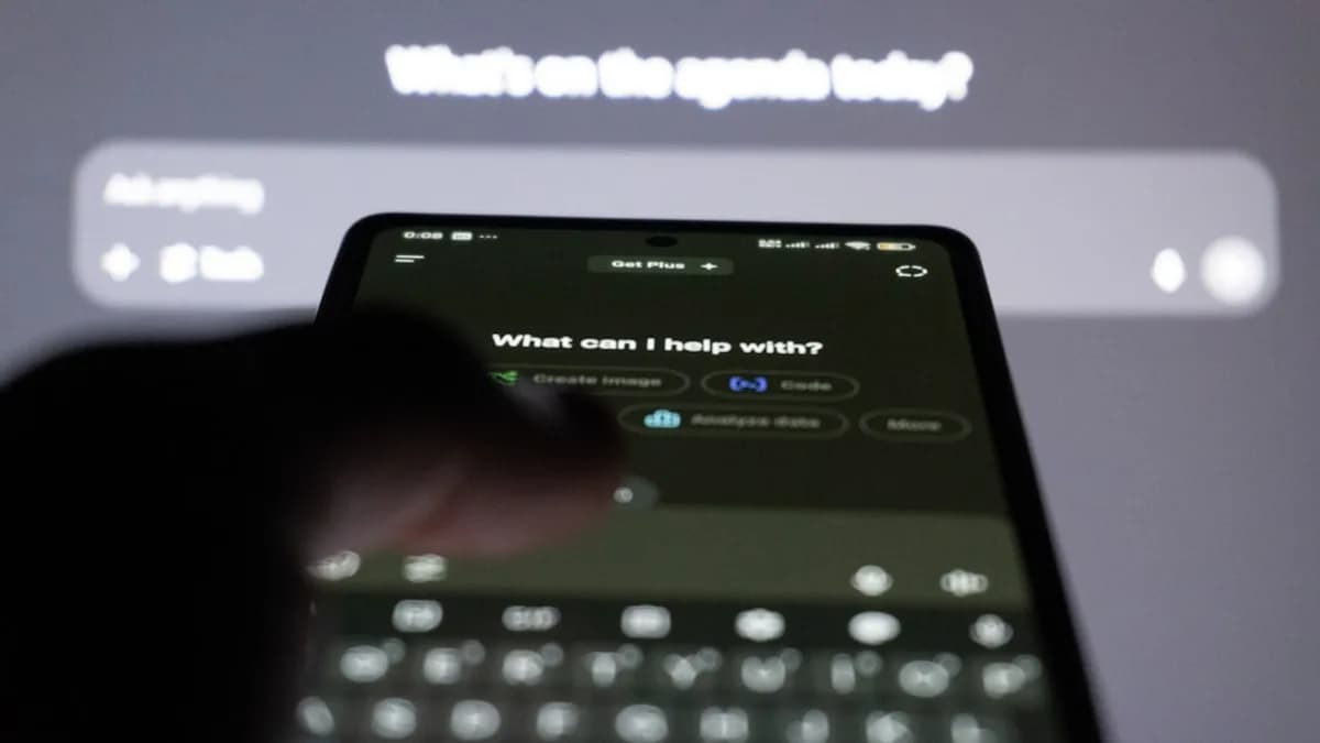 Person typing on smartphone with ai chatbot on screen.