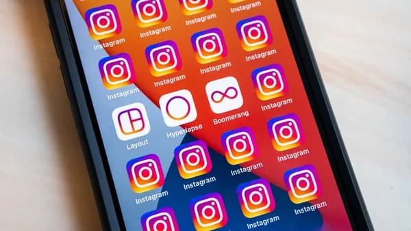 a cell phone with instagram stickers on the screen