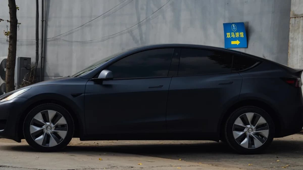 a black car parked on the side of a road