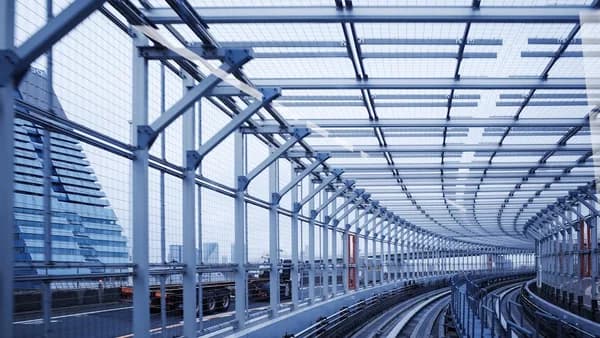 a train station with a large glass ceiling