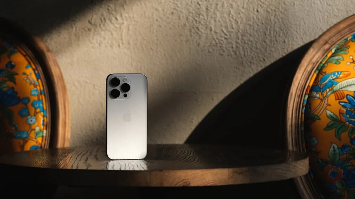 Silver smartphone resting on a wooden table
