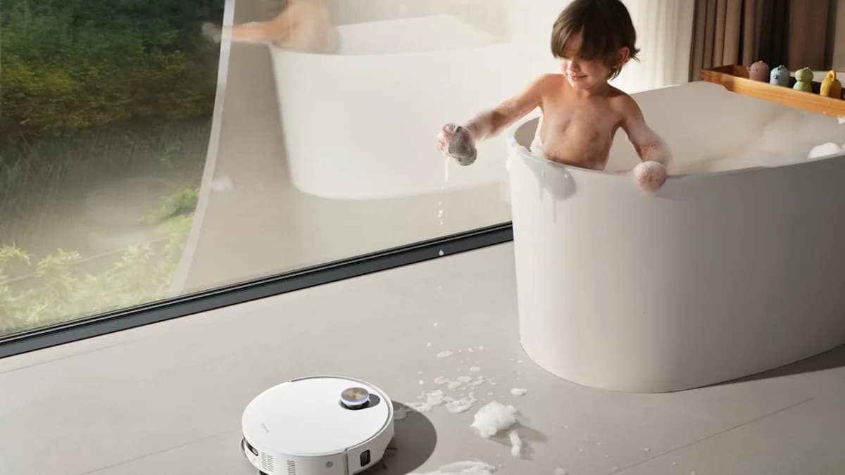 Child playing in bathtub with robot vacuum cleaner