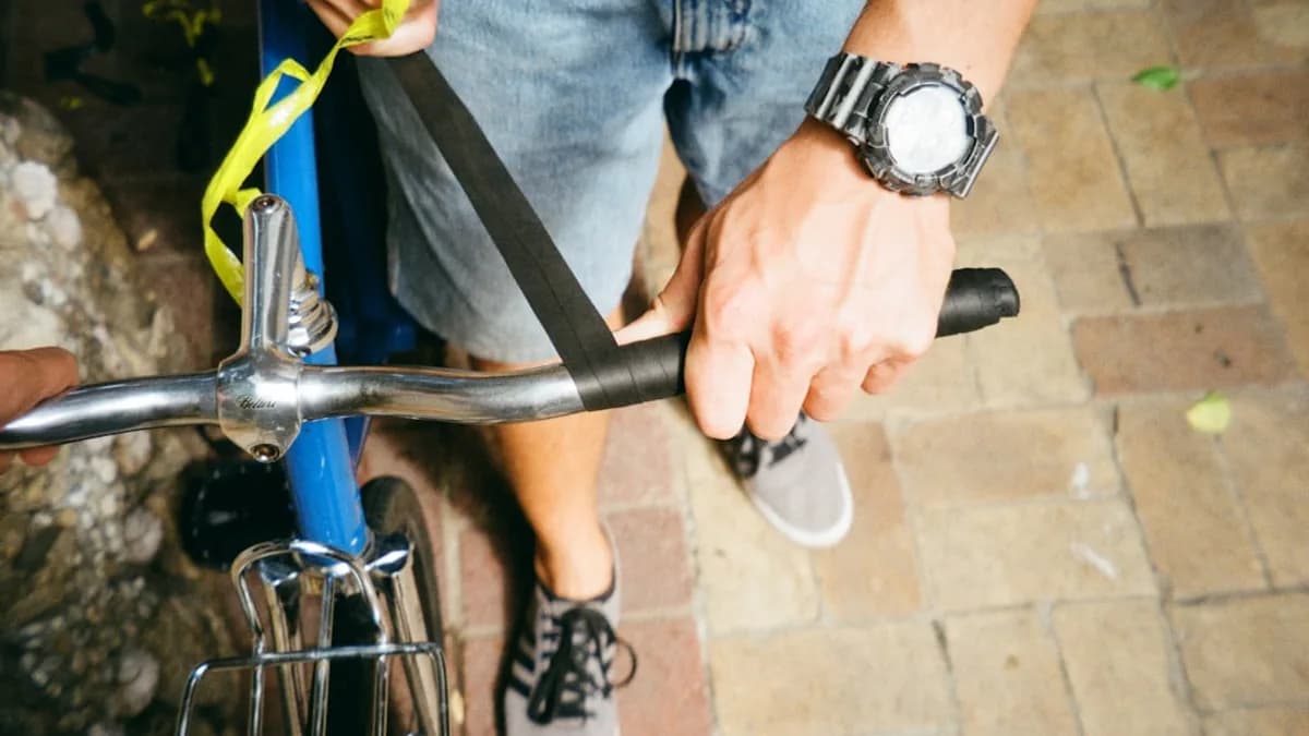 a close up of a person holding a bike handle