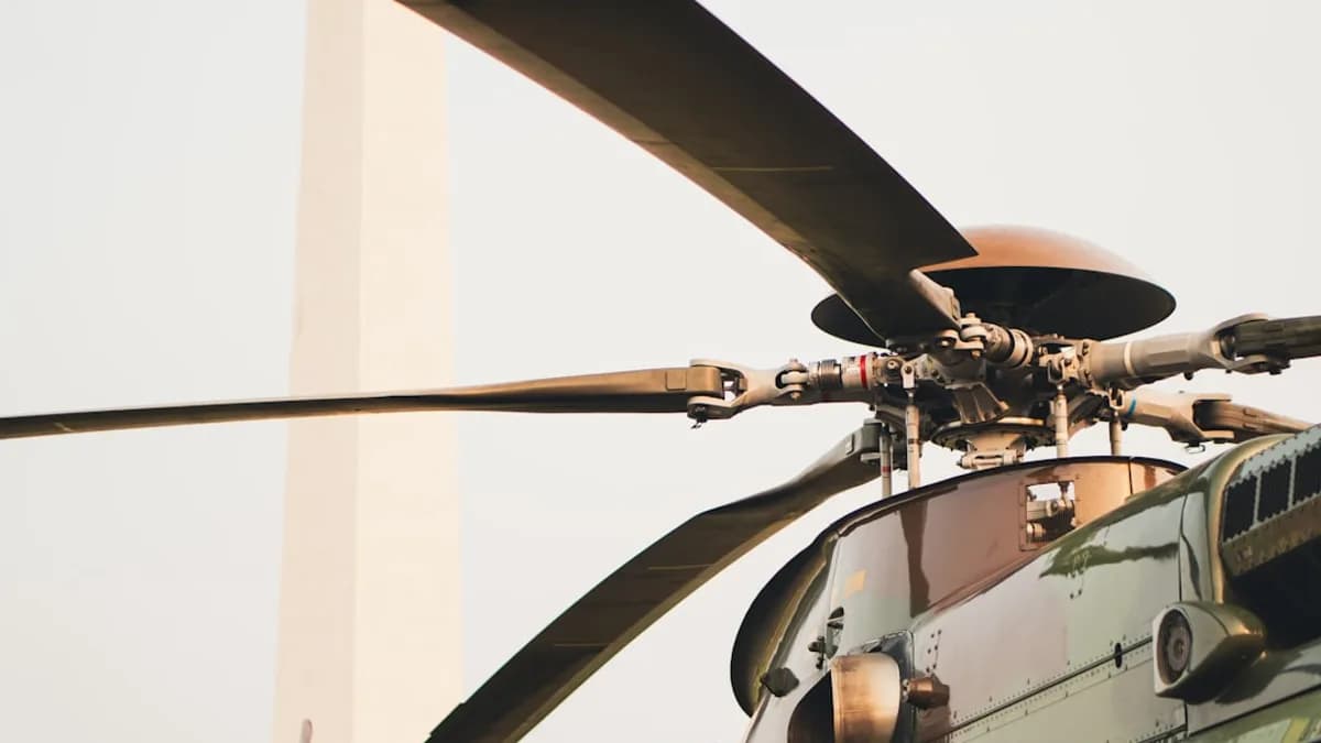 A close up of a military helicopter flying in the sky