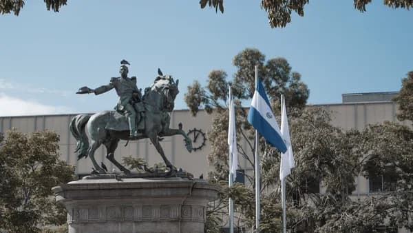 a statue of a man on a horse in front of a building