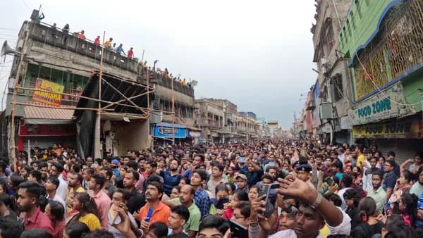 a large crowd of people standing in a street