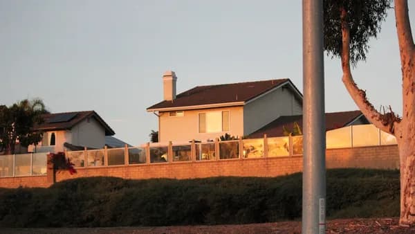 A street sign in front of a house
