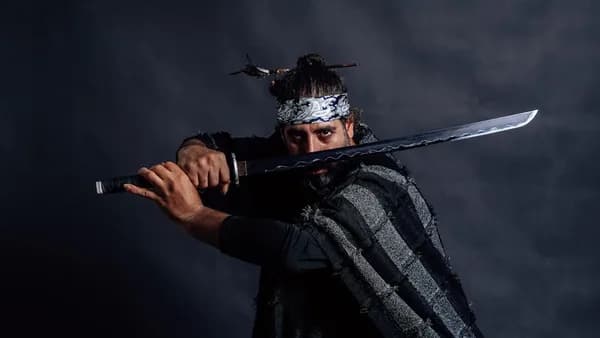 Samurai warrior prepares to strike with his sword.