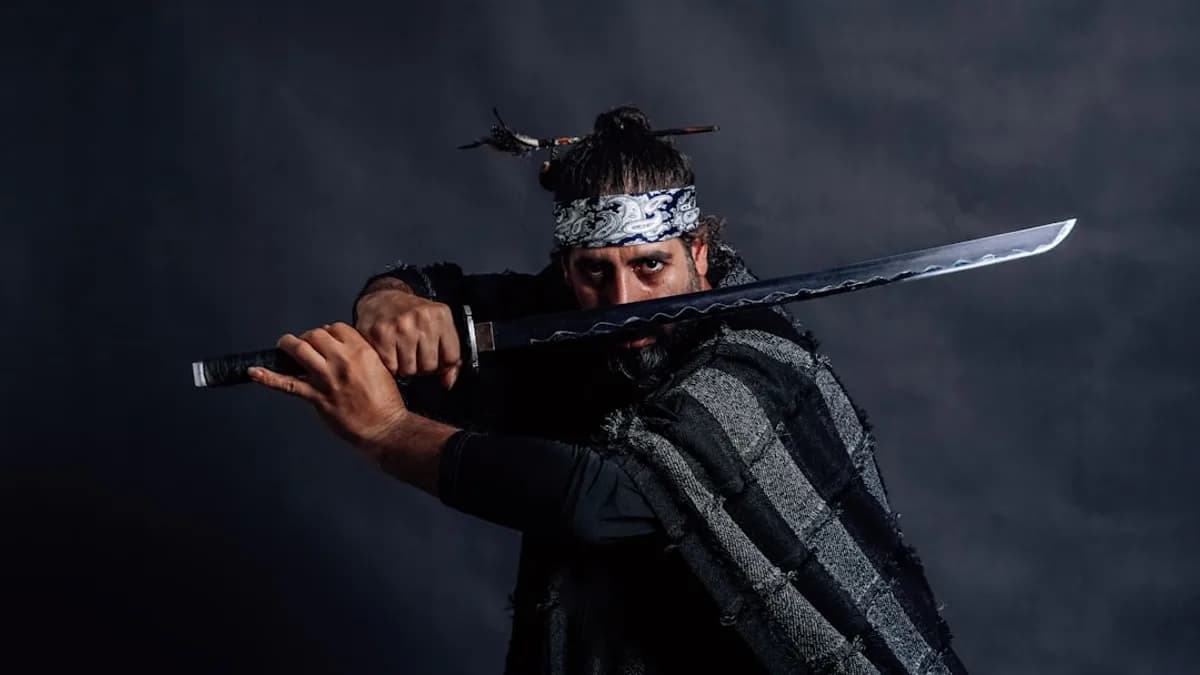 Samurai warrior prepares to strike with his sword.