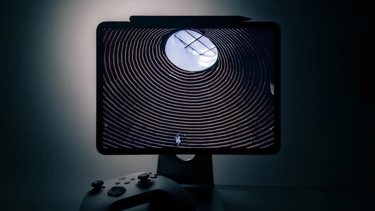 a computer screen with a video game controller in front of it