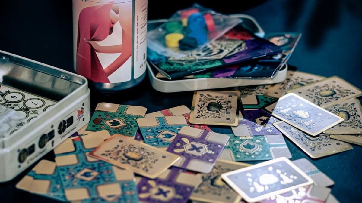 a can of beer sitting next to a pile of playing cards