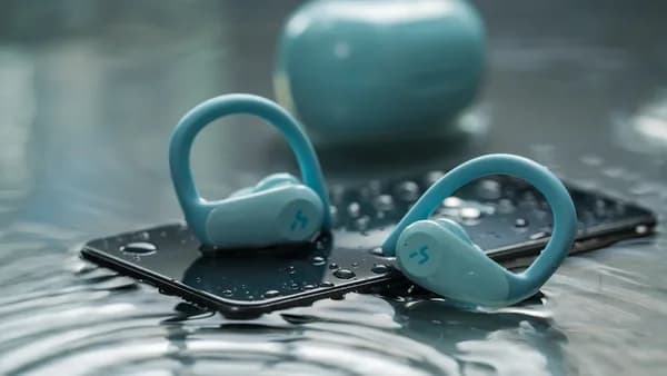 a pair of blue headphones sitting on top of a phone