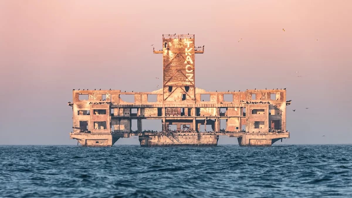 brown concrete building on body of water during daytime
