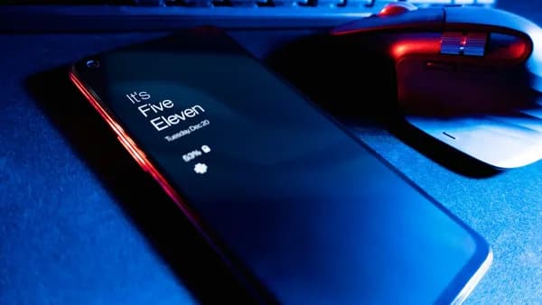 a close up of a cell phone near a keyboard