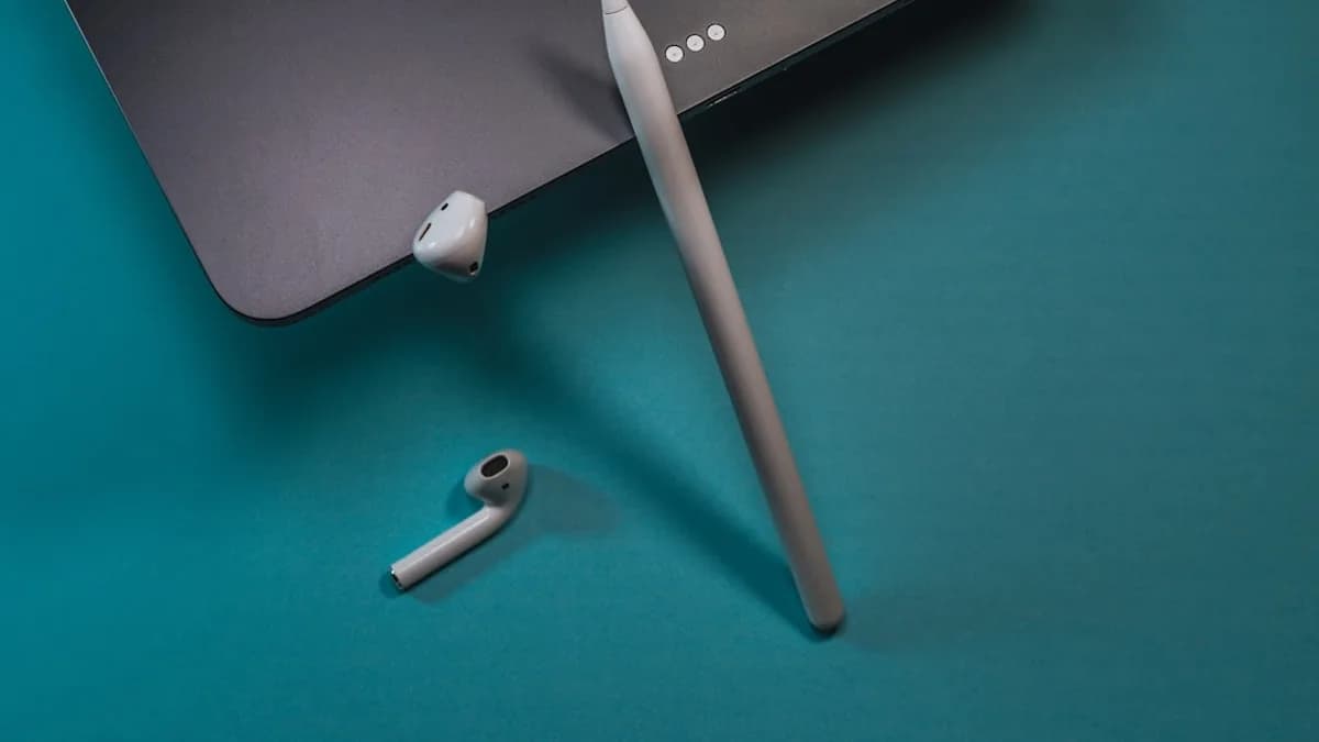 white earbuds on green table
