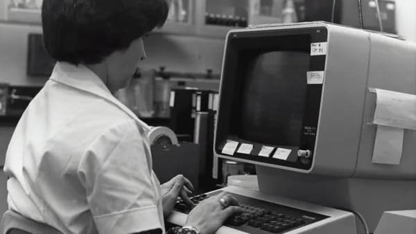 grayscale photography of unknown person using computer