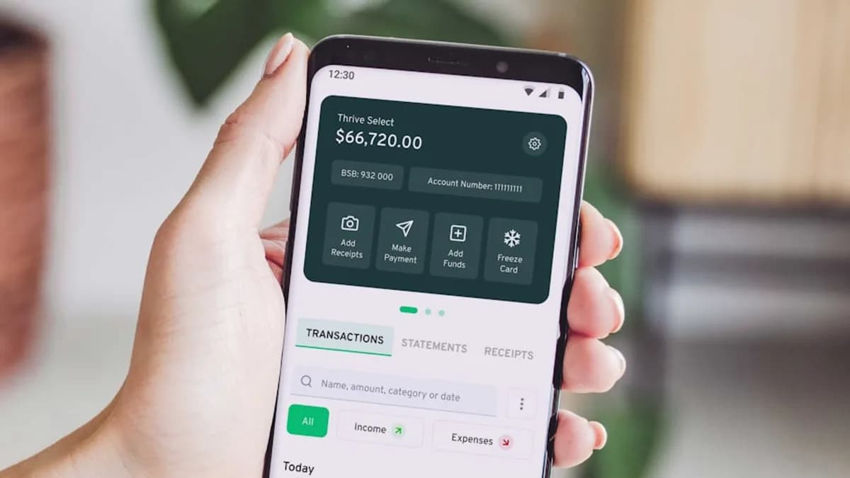a person holding up a smart phone with an app on the screen