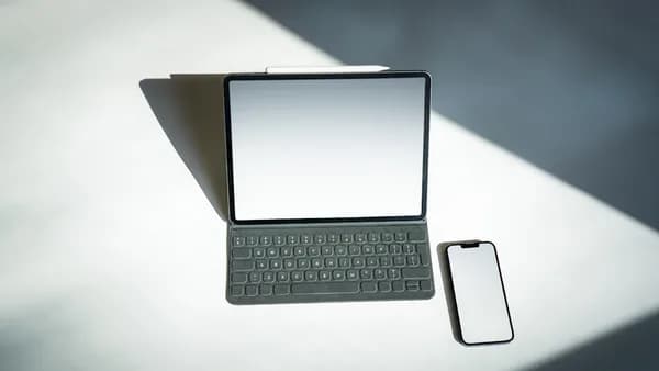 a tablet and a cell phone sitting on a table